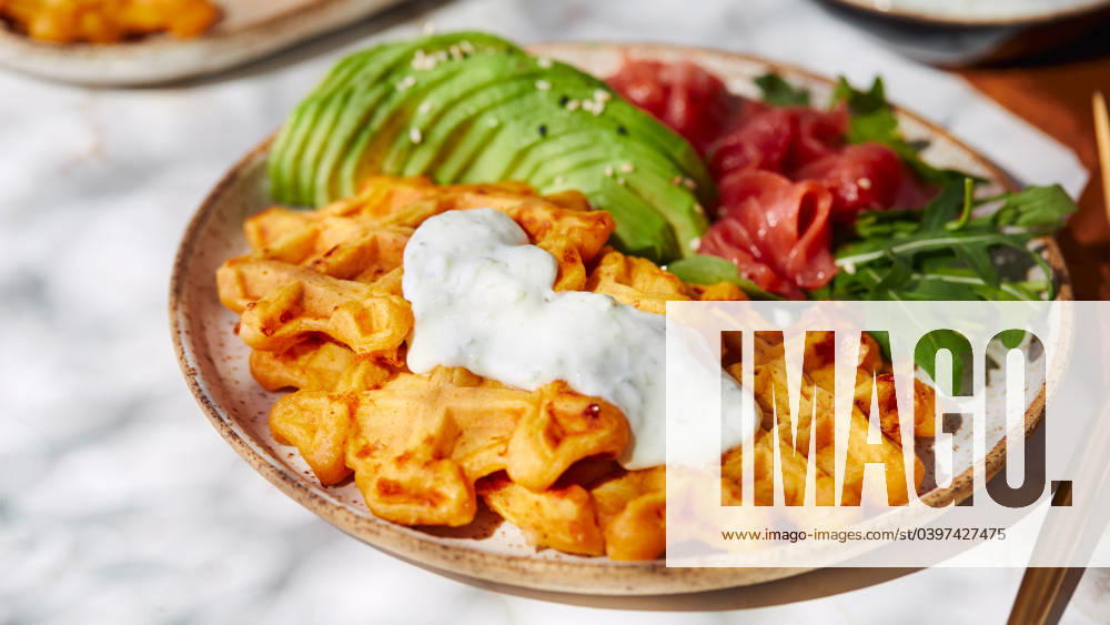 Hearty sweet potato or pumpkin waffles with avocado, salmon, arugula and sauce Hearty sweet potato or pumpkin waffles with avocado, salmon, arugula and sauce