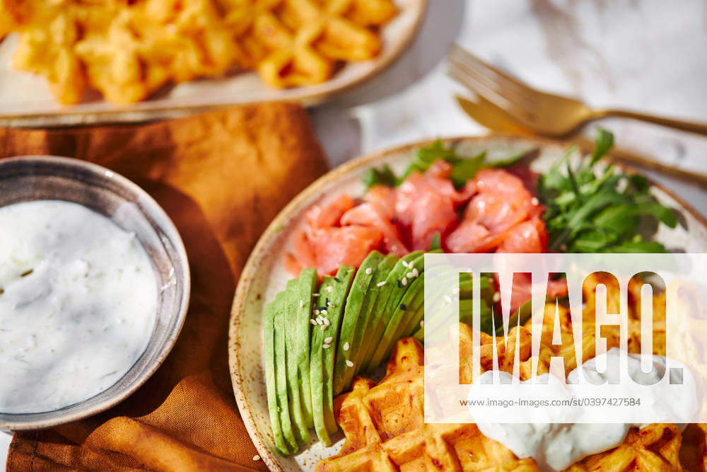 Hearty sweet potato or pumpkin waffles with avocado, salmon, arugula and sauce Hearty sweet potato or pumpkin waffles with avocado, salmon, arugula and sauce