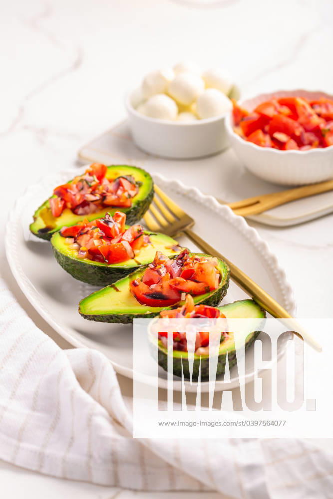 Avocados filled with bruschetta and balsamic vinaigrette - vegan appetizers Avocados filled with bruschetta and balsamic vinaigrette - vegan appetizers