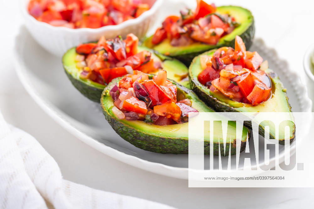 Avocados filled with bruschetta and balsamic vinaigrette - vegan appetizers Avocados filled with bruschetta and balsamic vinaigrette - vegan appetizers