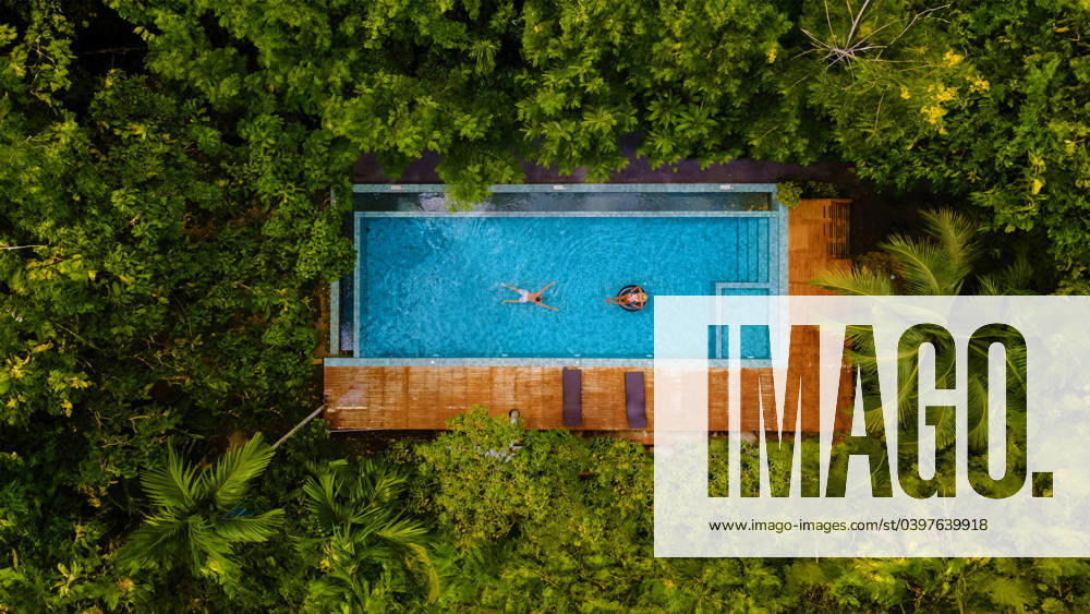Couple men and woman in swimming pool in the jungle of Krabi Thailand, drone view at rainforest couple of men and women in a swimming pool in the jungle of Krabi Thailand, aerial view with a drone above a swimming pool in the jungle rainforest of Thailand. ,model released, Symbolfoto