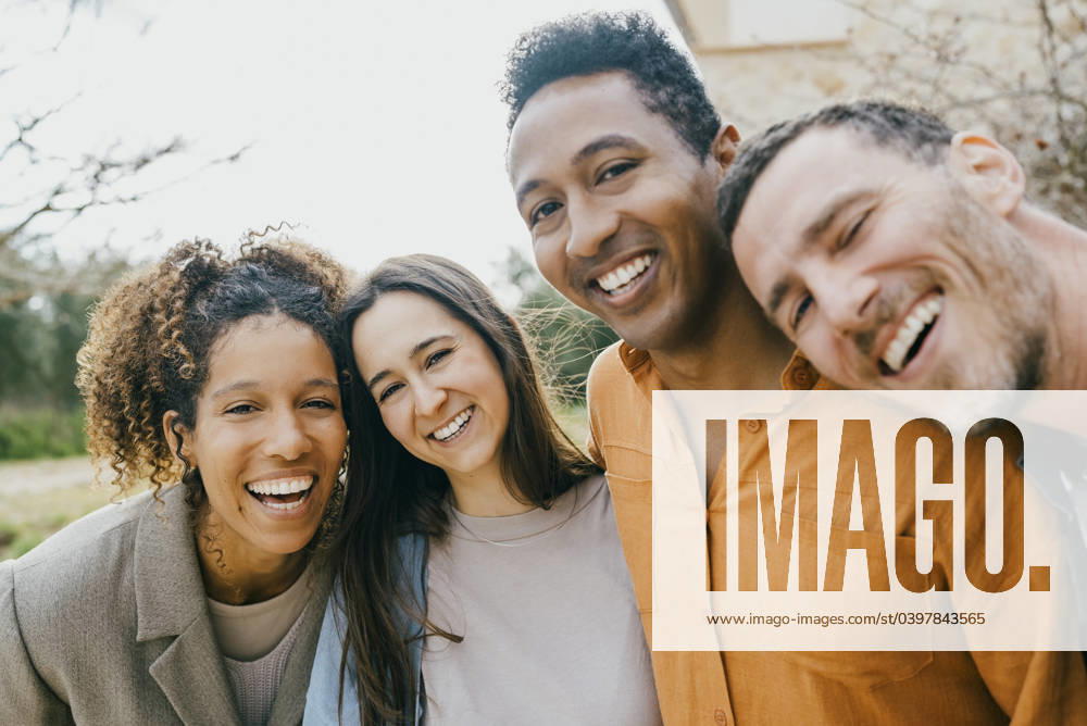 Portrait of happy multiracial male and female friends at backyard Spain, Mallorca, model released