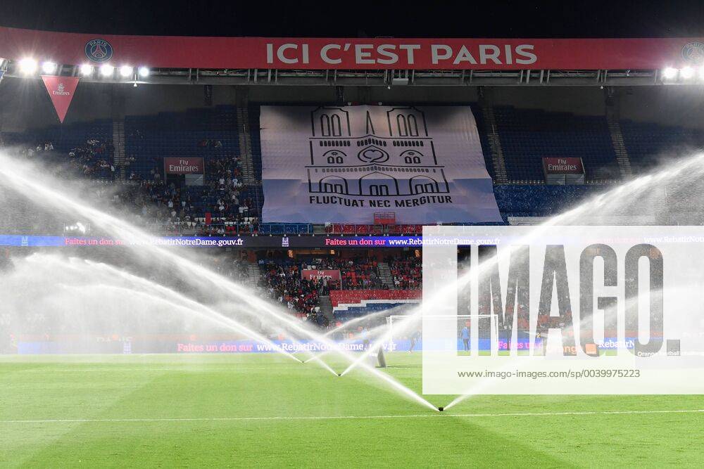 Paris, ile de france, France - water falls in front of a giant tiff in tribute to Notre Dame de Paris during the french Ligue 1 match between Paris Saint-Germain (PSG) and AS Monaco (ASM) at Parc des Princes stadium on 2019, April 21 in Paris, France. Paris Saint Germain v AS Monaco - French Ligue 1 - ZUMAn230 20190421_zaa_n230_438