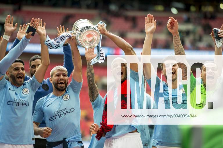 Vincent Kompany of Manchester City and his team mates lift the FA Trophy during The FA Cup Final match between Manchester City and Watford at Wembley Stadium, London, England on 18 May 2019.