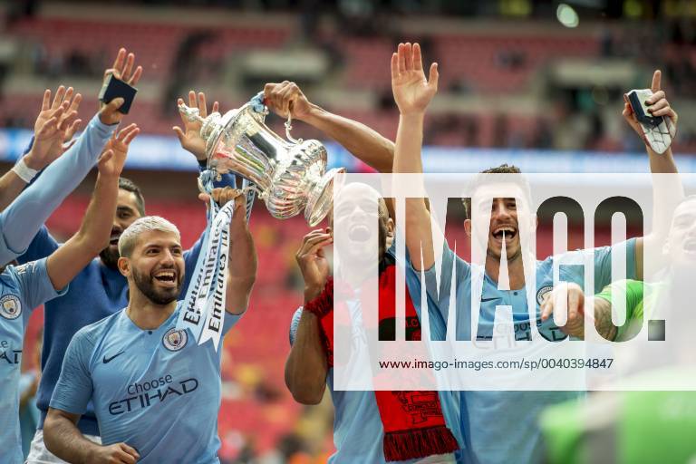 Vincent Kompany of Manchester City and his team mates lift the FA Trophy during The FA Cup Final match between Manchester City and Watford at Wembley Stadium, London, England on 18 May 2019.