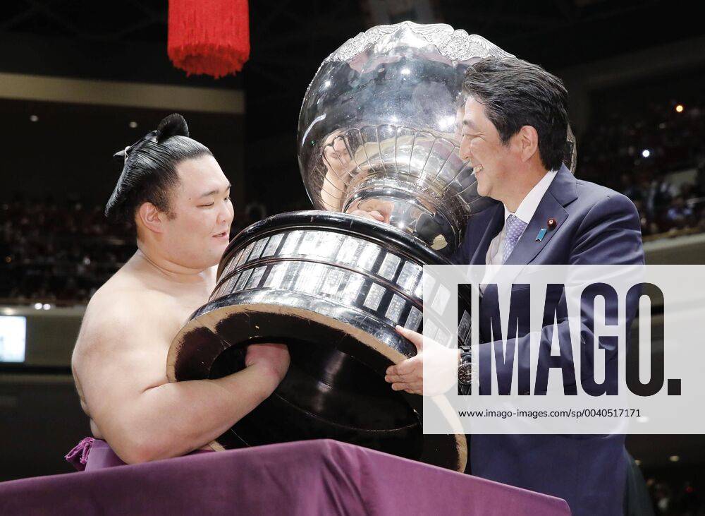 KW21 Summer Grand Sumo Tournament Summer Grand Sumo Tournament winner Asanoyama (L) receives a cup from Japanese Prime Minister Shinzo Abe at Tokyo s Ryogoku Kokugikan on May 26, 2019.