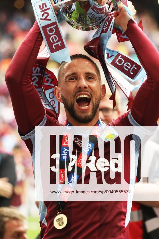 London, England, United Kingdom - Conor Hourihane (14) of Aston Villa holds the play off trophy following his sides win during the Sky Bet Championship Play Off Final between Aston Villa and Derby County at Wembley Stadium, London on Monday 27th May 2019. Aston Villa v Derby County - Sky Bet Championship Play-off Final - ZUMAn230 20190527_zaa_n230_852
