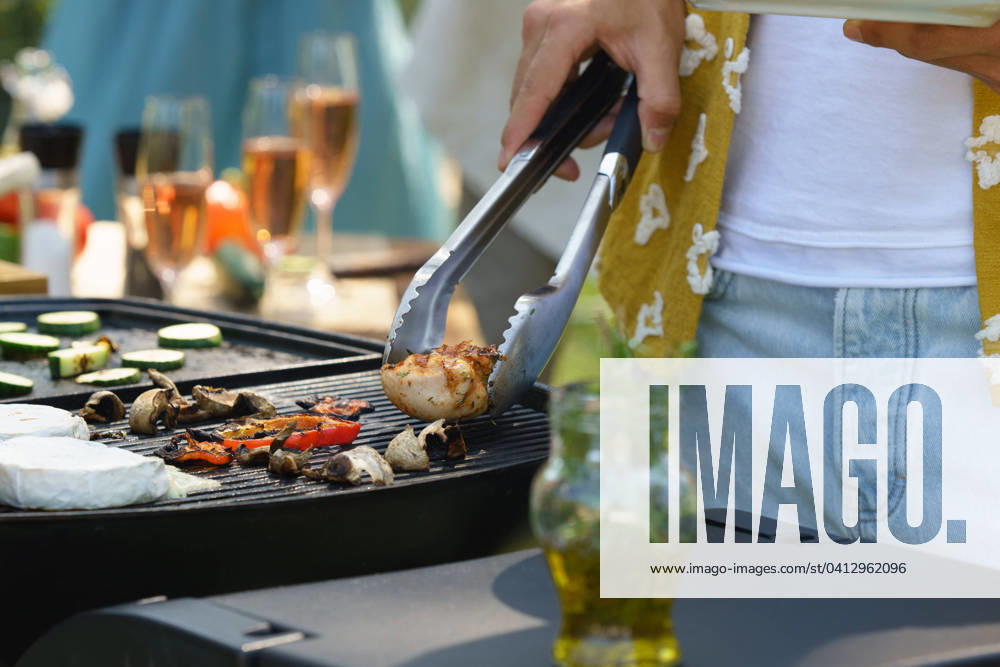 Meat and vegetables grilling on outdoor grill. Outdoor grill or BBQ party in the garden. Meat and vegetables grilling on an outdoor grill. Outdoor grill or BBQ party in the garden. model released