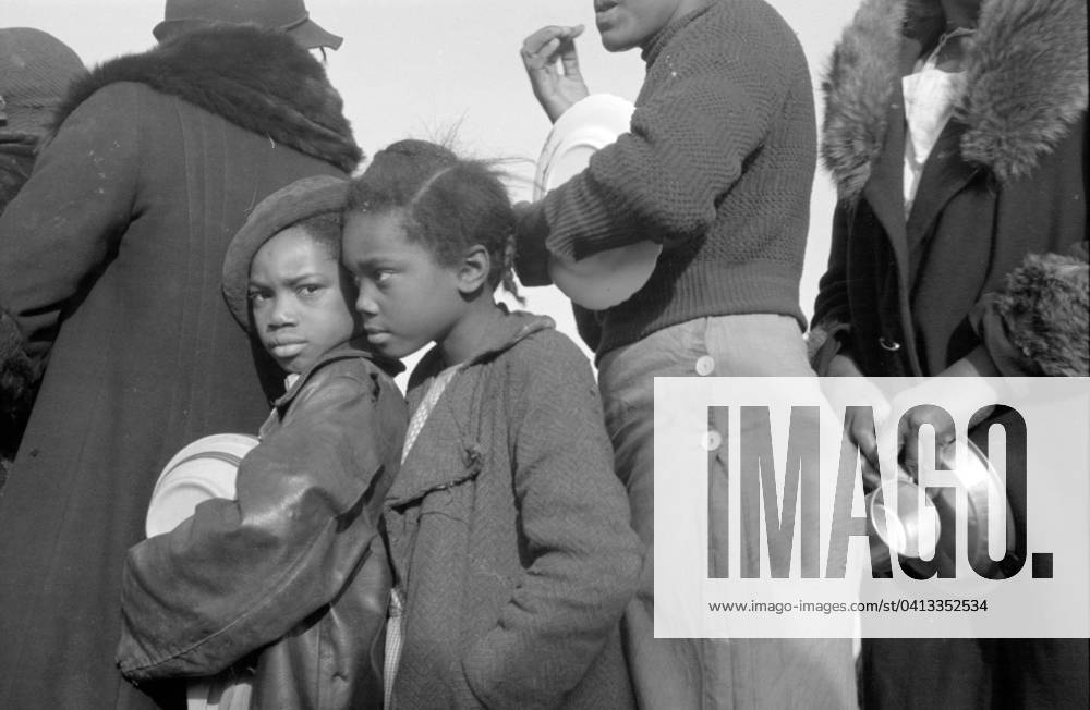 African Americans in the lineup for food at mealtime in the camp for flood refugees at Forrest City, Arkansas, 1937 (b w photo) 3666438 African Americans in the lineup for food at mealtime in the camp for flood refugees at Forrest City, Arkansas, 1937 (b w photo) by Evans, Walker (1903-75); Private Collection; (add.info.: Photograph taken for the U.S. Resettlement Administration: a New Deal U.S. federal agency that, between April 1935 and December 1936, relocated struggling urban and rural families to communities planned by the federal government.).