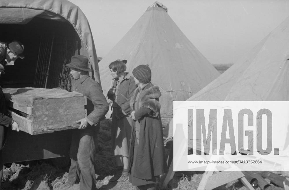 Unloading household goods of a family of white flood refugees in camp at Forrest City, Arkansas, 1937 (b w photo) 3666448 Unloading household goods of a family of white flood refugees in camp at Forrest City, Arkansas, 1937 (b w photo) by Evans, Walker (1903-75); Private Collection; (add.info.: Photograph taken for the U.S. Resettlement Administration: a New Deal U.S. federal agency that, between April 1935 and December 1936, relocated struggling urban and rural families to communities planned by the federal government. ).