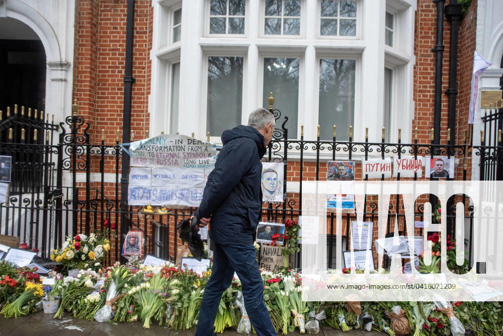 A man looks at flowers, tributes and pictures of Alexei Navalny as he walks past the Boris Nemstov Place opposite the Russian Embassy in London. Alexei Navalny of 47 years old died on the 16th of February 2024 in the Arctic penal colony after his morning walk according to the Russian official version. He was a fierce opponent of the Russian President Vladimir Putin. Since Navalny s death the mourners lay floral tributes for him outside the Russian Embassy in London. London United Kingdom - ZUMAs197 20240221_aab_s197_028