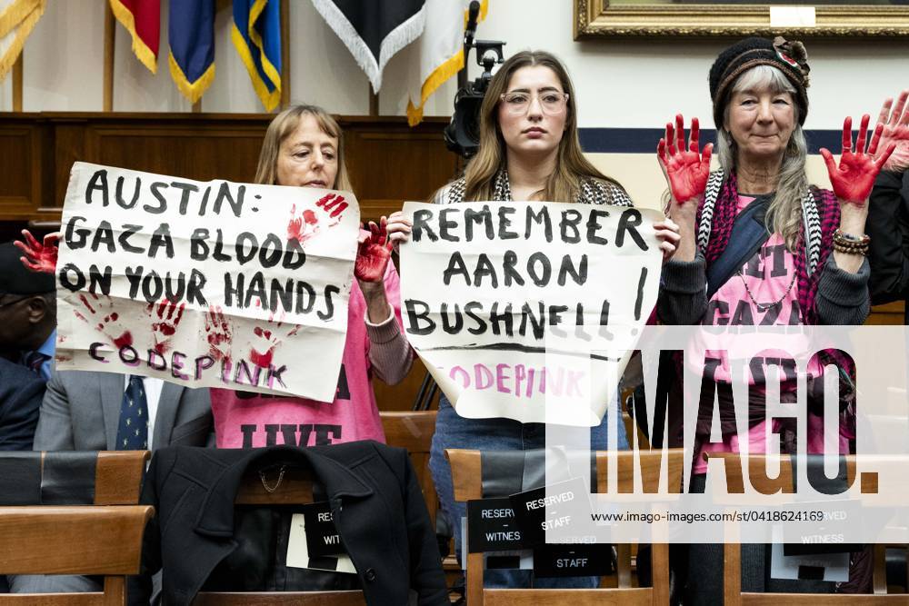 Activists holding signs saying Austin: Gaza blood on your hands and Remember Aaron Bushnell! at a hearing of the House Committee on Armed Services at the U.S. Capitol. Washington USA - ZUMAb161 20240229_aap_b161_004