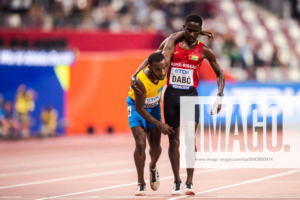 Braima Suncar Daibo helps Jonathan Busby during the men?s 5000 meter qualification during day 1 of the IAAF World Athletics Championships on September 27, 2019 in Doha. Photo: Joel Marklund BILDBYRAN kod JM 88031 bbeng athletics track & field friidrott friidrett iaaf world athletics championships athletics World Championship, WM, Weltmeisterschaft vm friidrotts-vm friidretts-vm