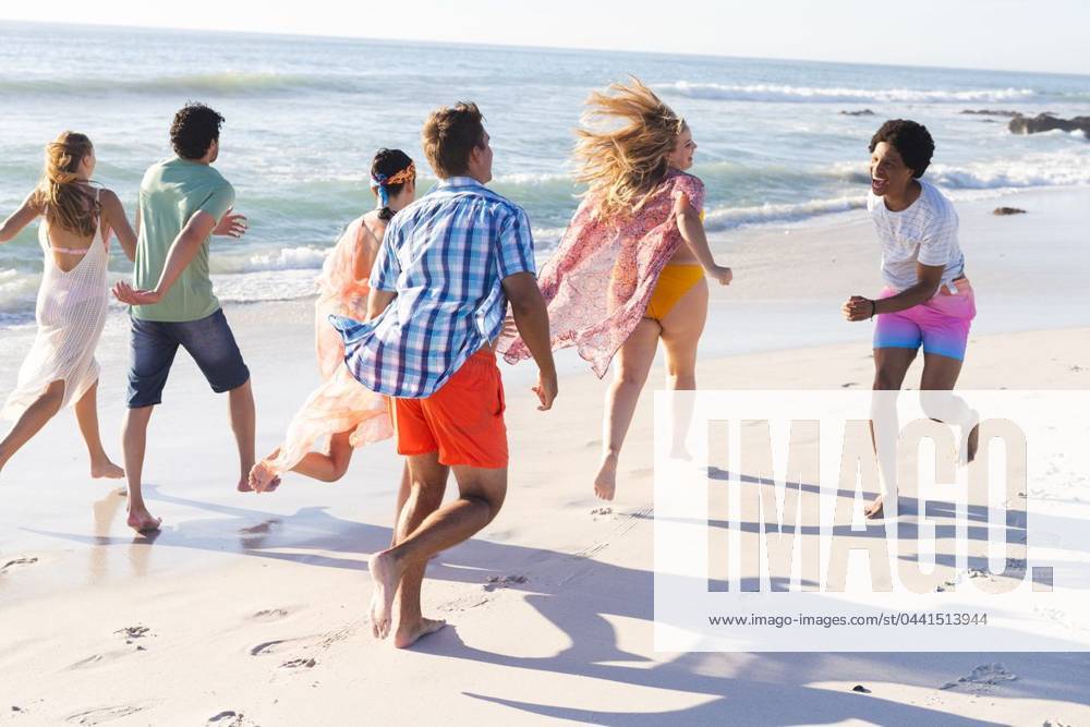 Diverse group of friends enjoy a beach outing Diverse group of friends enjoy a beach outing. They are running along the shoreline, embodying a carefree summer vibe., model released, , property released, Cape Town, South Africa, 2024-01-23T22:00:00.000Z, 5113175.jpg, people,beach,outing,diverse group,friends,running,shoreline,carefree,summer,vibe,happy,joyful,multicultural,diverse,sea,ocean,vacation,holiday,leisure,activity,fun,sun,sand,happiness,enjoyment,outdoor,tropical,waves,relaxation,unity,diversity,group,togetherness,summer vibe,copy space Young Adult,Man,Male,Multiracial,Black,Woman,Female,White