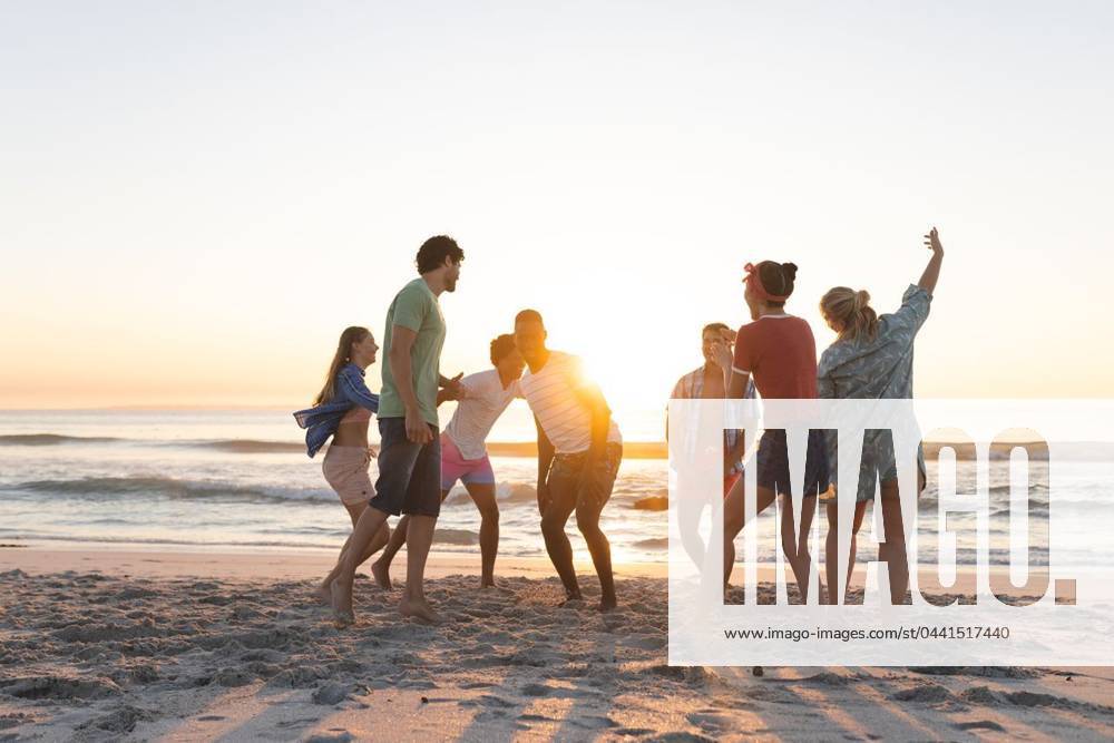 Diverse group of friends enjoy a beach outing at sunset Diverse group of friends enjoy a beach outing at sunset. Laughter fills the air as they share a playful moment by the sea., model released, , property released, Cape Town, South Africa, 2024-01-23T22:00:00.000Z, 5113250.jpg, people,diverse,group,friends,beach,outing,sunset,laughter,playful,moment,sea,ocean,relaxing,enjoy,happiness,joy,sunlight,outdoors,nature,vacation,travel,bonding,companionship,diversity,inclusion,summer,vibe,friendship,togetherness,leisure,activity,beachwear,sundown,dusk,seaside,coastline,shore,waves,sand,horizon,sky,clouds,sun,water,oceanic,evening,tropical,seafront,coast,tranquility,beautiful Young Adult,Man,Male,Black,Multiracial,Woman,Female,White