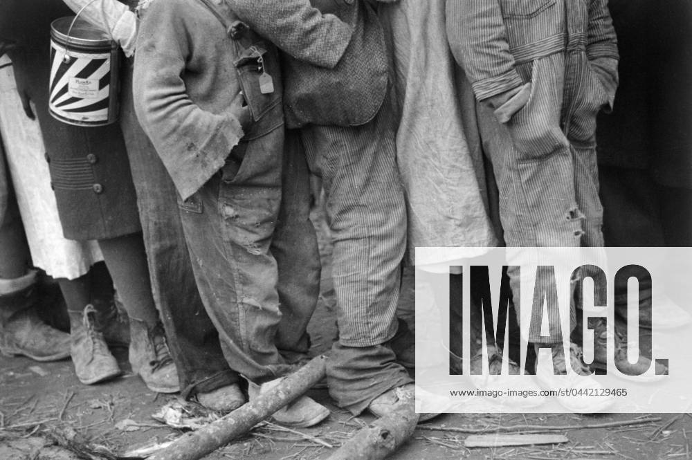 FLOOD REFUGEES, 1937. African Americans in line at mealtime in a flood refugee temporary infirmary operated by the Red Cross at Forrest City, Arkansas. Photograph by Walker Evans in February 1937.