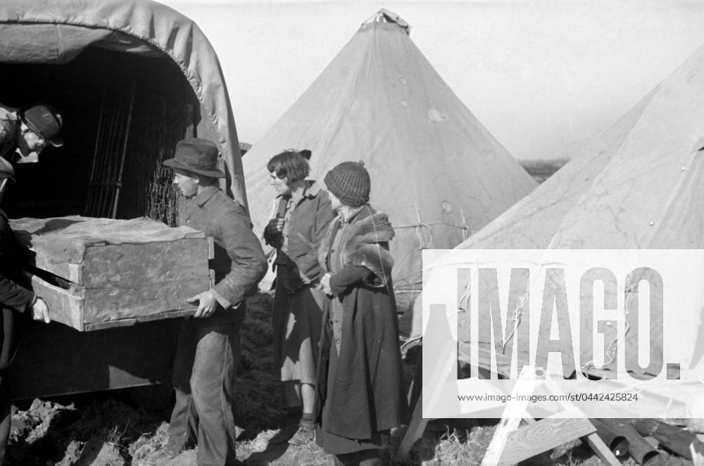 ARKANSAS: FLOOD CAMP, 1937. A family moving into a camp for white flood refugees at Forrest City, Arkansas. Photograph by Walker Evans, February 1937.