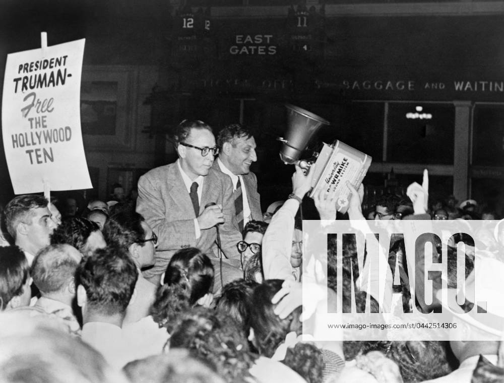 HOLLYWOOD TEN, 1950. Dalton Trumbo and John Howard Lawson, surrounded by supporters, on their way to prison, having been being found in contempt of Congress for refusing to provide information regarding Communism in Hollywood. Photograph, 1950.