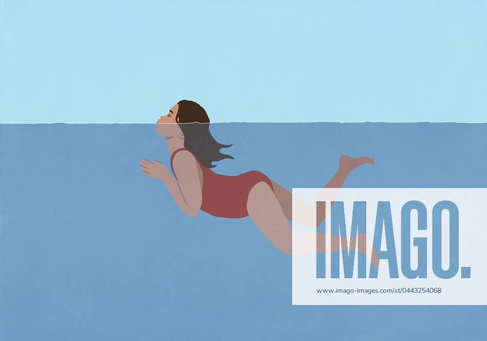 Girl in bathing suit swimming with head above water