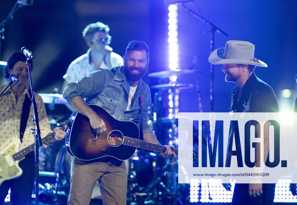 American country rock band NEEDTOBREATHE with lead singer BEAR RINEHART, r, teams up with country pop singer JORDAN DAVIS performs at a taping of CMT Country Crossroads in front of the University of Texas Tower on April 5, 2024. Austin United States - ZUMAd150 20240405_znp_d150_022