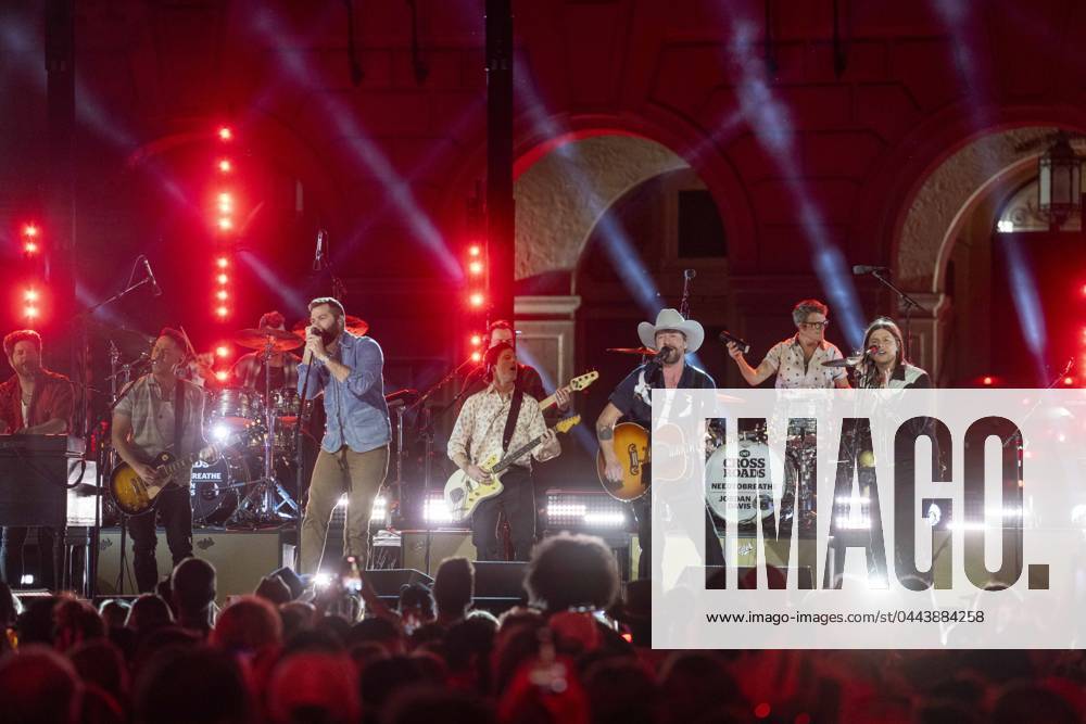 American country rock band NEEDTOBREATHE with lead singer BEAR RINEHART, r, teams up with country pop singer JORDAN DAVIS, l, to perform at a taping of CMT Country Crossroads in front of the University of Texas Tower on April 5, 2024. At far right is bassist SETH BOLT. Austin United States - ZUMAd150 20240405_znp_d150_034