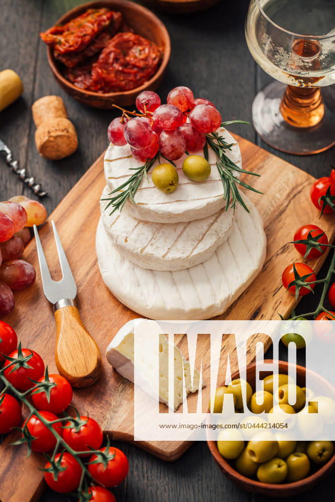 Cheese platter with brie Cheese platter with brie, Camembert, grapes, olives and tomatoes
