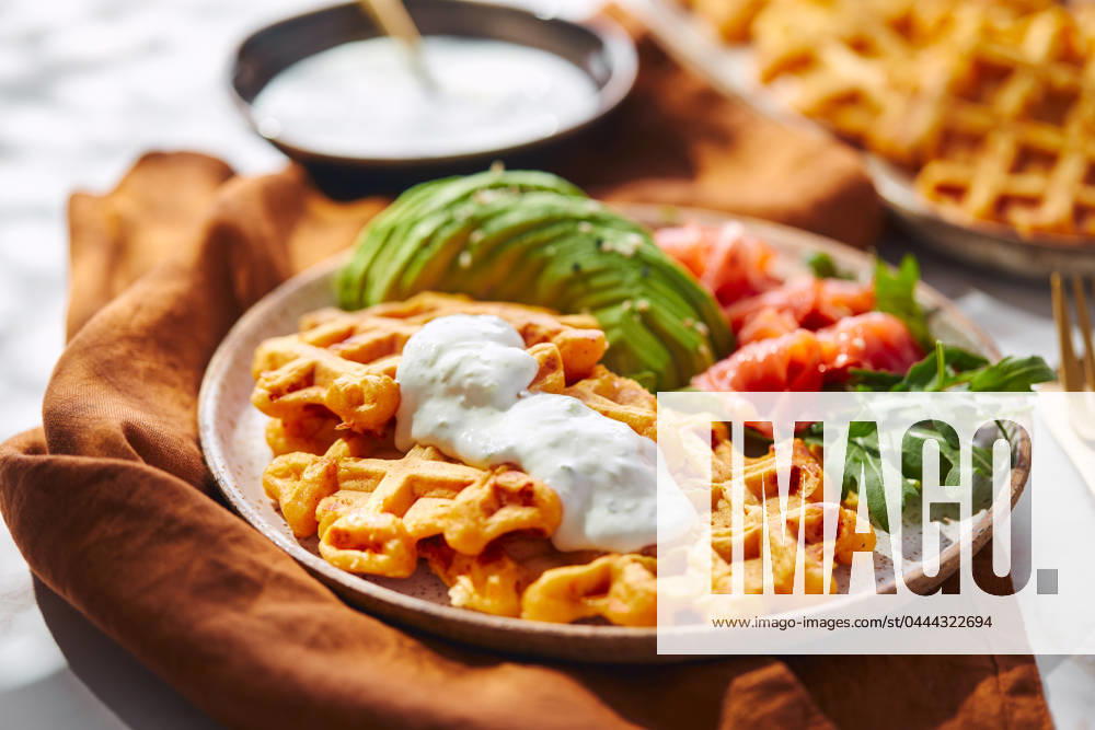 Hearty sweet potato or pumpkin waffles with avocado, salmon, arugula and sauce Hearty sweet potato or pumpkin waffles with avocado, salmon, arugula and sauce