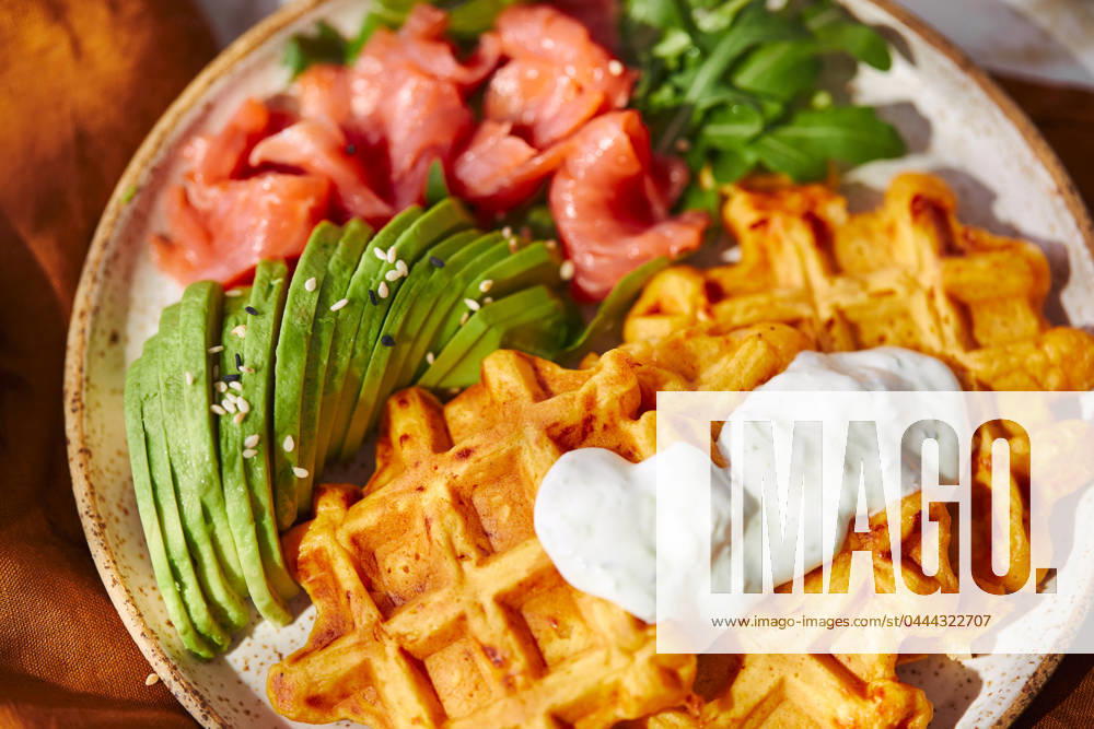 Hearty sweet potato or pumpkin waffles with avocado, salmon, arugula and sauce Hearty sweet potato or pumpkin waffles with avocado, salmon, arugula and sauce