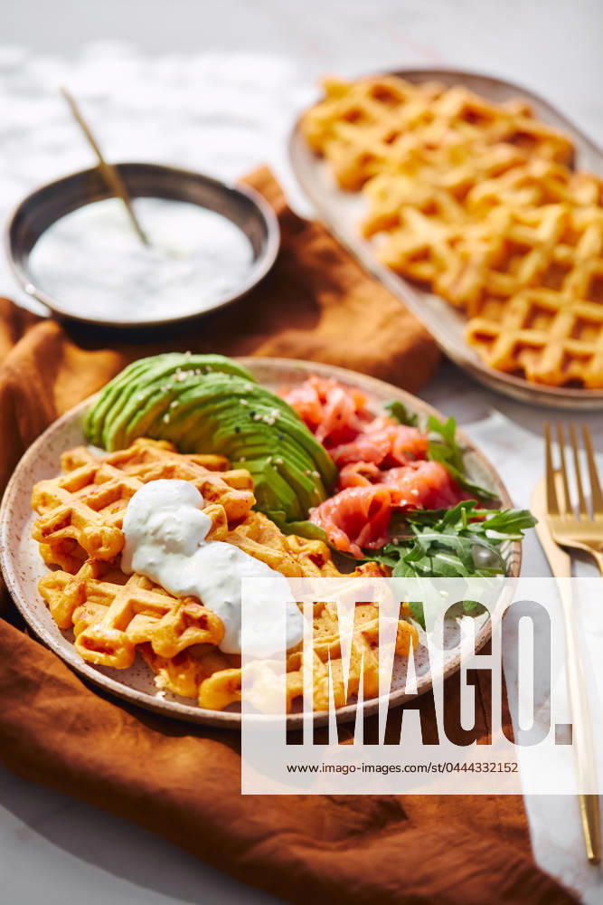 Hearty sweet potato or pumpkin waffles with avocado, salmon, arugula and sauce Hearty sweet potato or pumpkin waffles with avocado, salmon, arugula and sauce
