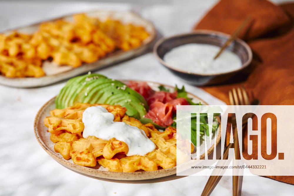 Hearty sweet potato or pumpkin waffles with avocado, salmon, arugula and sauce Hearty sweet potato or pumpkin waffles with avocado, salmon, arugula and sauce