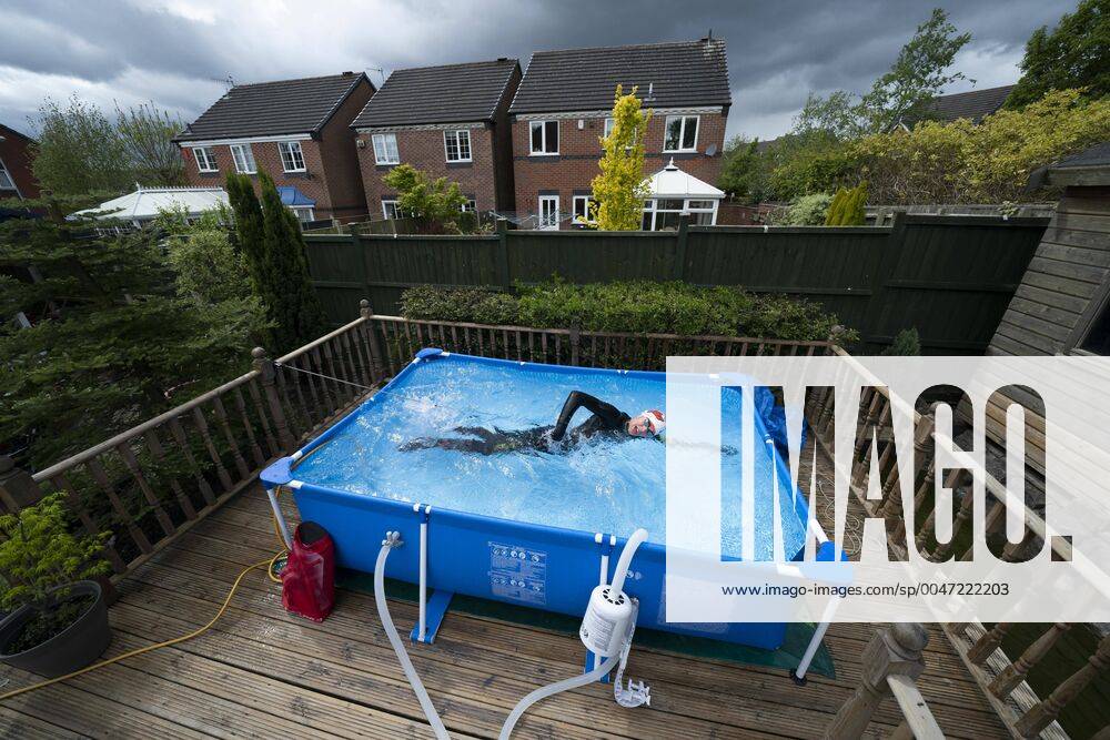 KW18 (200501) -- NEWCASTLE-UNDER-LYME, May 1, 2020 -- British triathlete Lloyd Bebbington trains in a temporary swimming pool in his garden because of the coronavirus lockdown restrictions in Newcastle-under-Lyme, Britain on April 30, 2020. (Photo by Xinhua) (SP)BRITAIN-NEWCASTLE-UNDER-LYME-COVID-19-TRIATHLETE TRAINING AT HOME JonxSuper