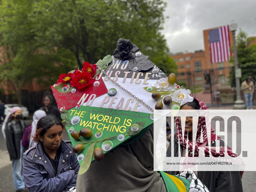A college grads mortarboard shows her solidarity with her Palestinian homeland. The colors represent the Palestinian flag, with statements such as the whole world is watching addressing the ongoing war between Israel and Hamas. Washington USA - ZUMAd155 20240510_znp_d155_002