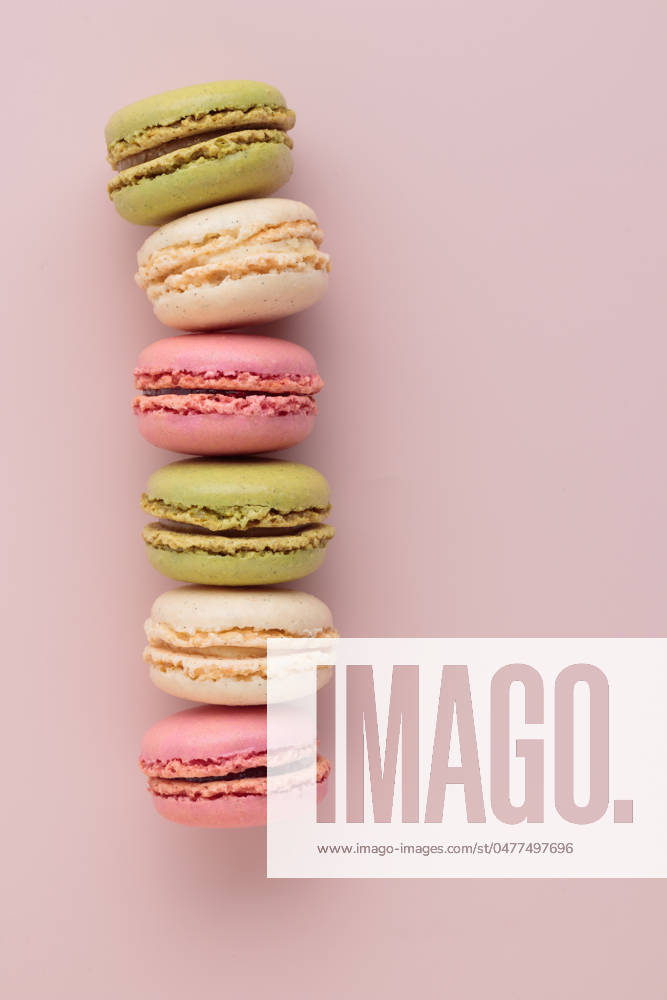 Macaroons on pink background, colorful french cookies pattern. Gift for 8 March, International Women s Day, Valentine Day Macaroons on pink background, colorful french cookies pattern. Gift for 8 March, International Women s Day, Valentine Day. Vertical banner with copyspace