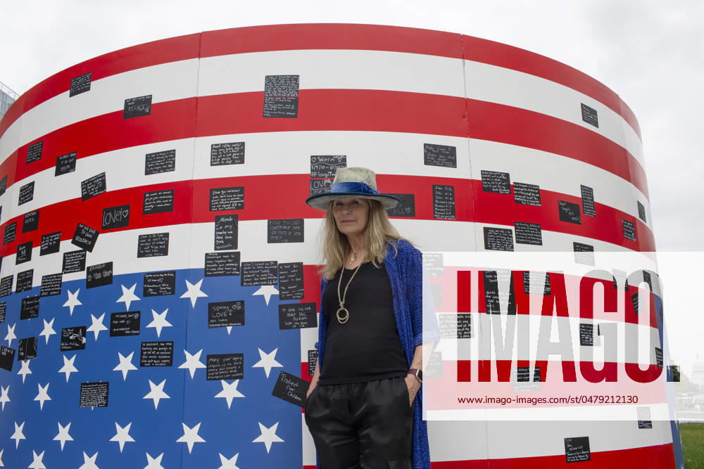 Acclaimed visual artist Suzanne Brennan Firstenberg poses for a photograph with her art installation alienable right to life, at Freedom Plaza in Washington, D.C. The installation features a massive American flag created from the names of 1,039 mass shooting victims overlaying an image of the Declaration of Independence. Additional elements are an original poem addressing all victims of gun violence, and a circular mural for visitors to share personal stories. Washington USA - ZUMAr125 20240519_fap_r125_003
