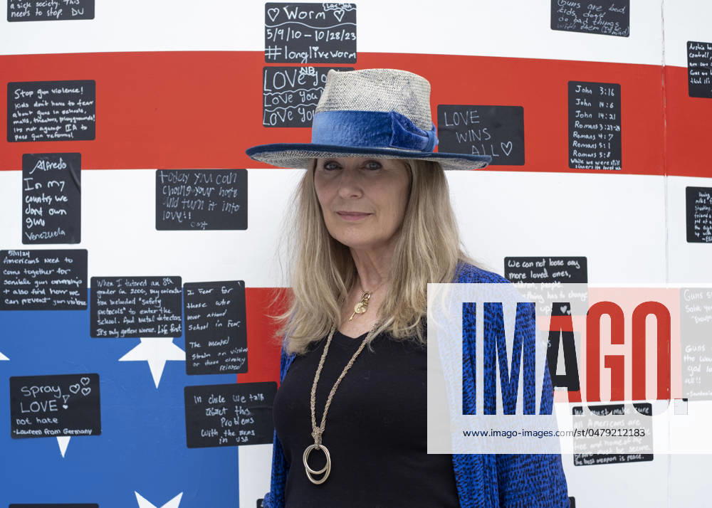Acclaimed visual artist Suzanne Brennan Firstenberg poses for a photograph with her art installation alienable right to life, at Freedom Plaza in Washington, D.C. The installation features a massive American flag created from the names of 1,039 mass shooting victims overlaying an image of the Declaration of Independence. Additional elements are an original poem addressing all victims of gun violence, and a circular mural for visitors to share personal stories. Washington USA - ZUMAr125 20240519_fap_r125_005