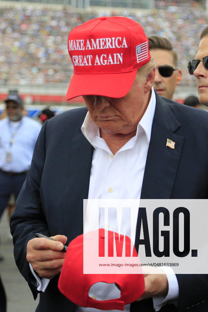 CHARLOTTE, NC - MAY 26: Former President of the United States of America Donald Trump signs an autograph for a fan on pit road prior to the running of the NASCAR Cup Series Coca-Cola 600 on May 26, 2024 at Charlotte Motor Speedway in Charlotte, NC. (Photo by Jeff Robinson Icon Sportswire) Icon1045686854