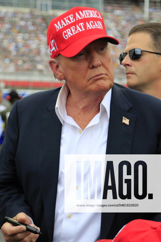 CHARLOTTE, NC - MAY 26: Former President of the United States of America Donald Trump signs an autograph for a fan on pit road prior to the running of the NASCAR Cup Series Coca-Cola 600 on May 26, 2024 at Charlotte Motor Speedway in Charlotte, NC. (Photo by Jeff Robinson Icon Sportswire) Icon1045686857