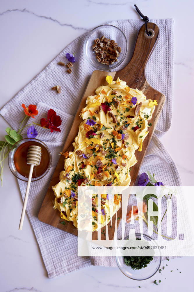 Herb, pecan and edible flowers butter board. Herb, pecan and edible flowers butter board.
