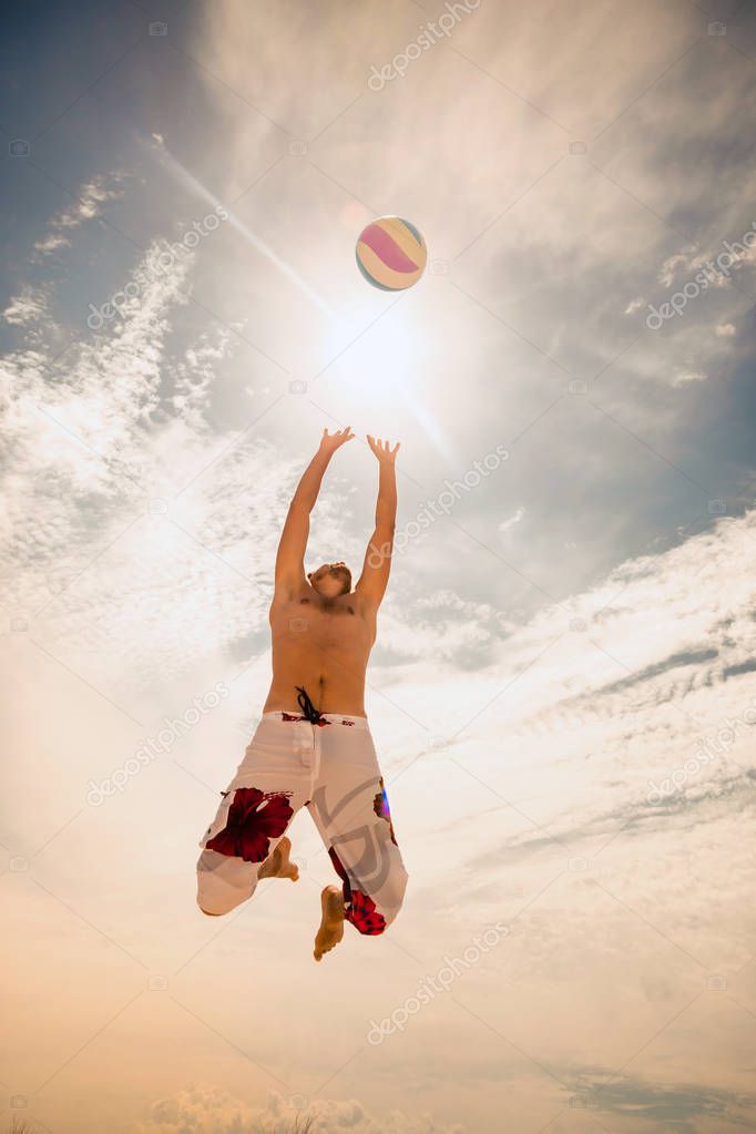 Male beach volleyball game player jump on hot sand model released