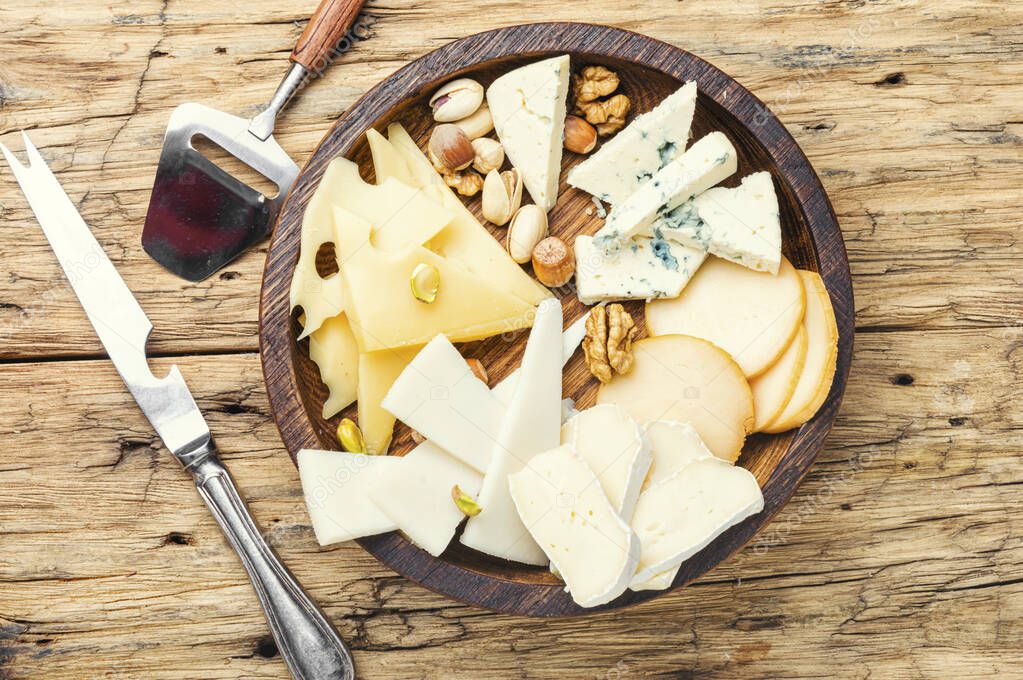 Cheese on the table.various types of cheese on old rustic wooden table