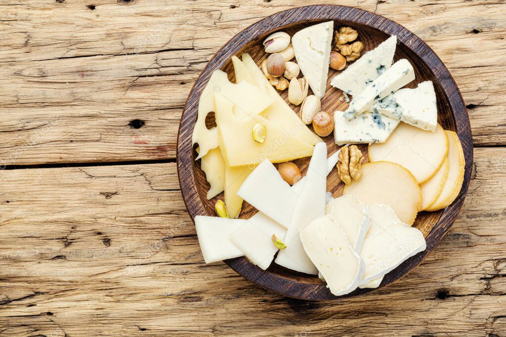 Cheese on the table.various types of cheese on old rustic wooden table