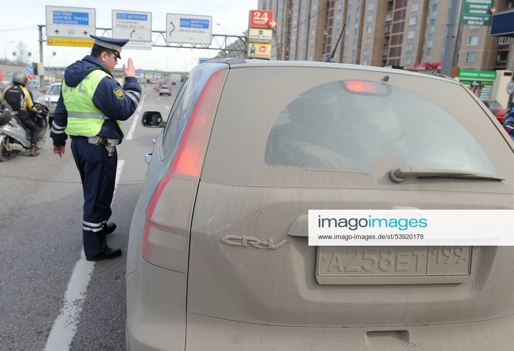 MOSCOW, RUSSIA. APRIL 6, 2010. GIBDD officer stops a car for a routine check during an annual spring campaign by Moscow traffic police to encourage drivers to keep their vehicles and the number plates clean. RE0CC32B