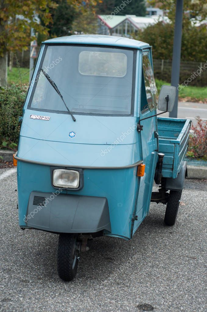 Mulhouse - France - 10 November 2019 - Front view of blue vintage piaggio tricycle parked in the street