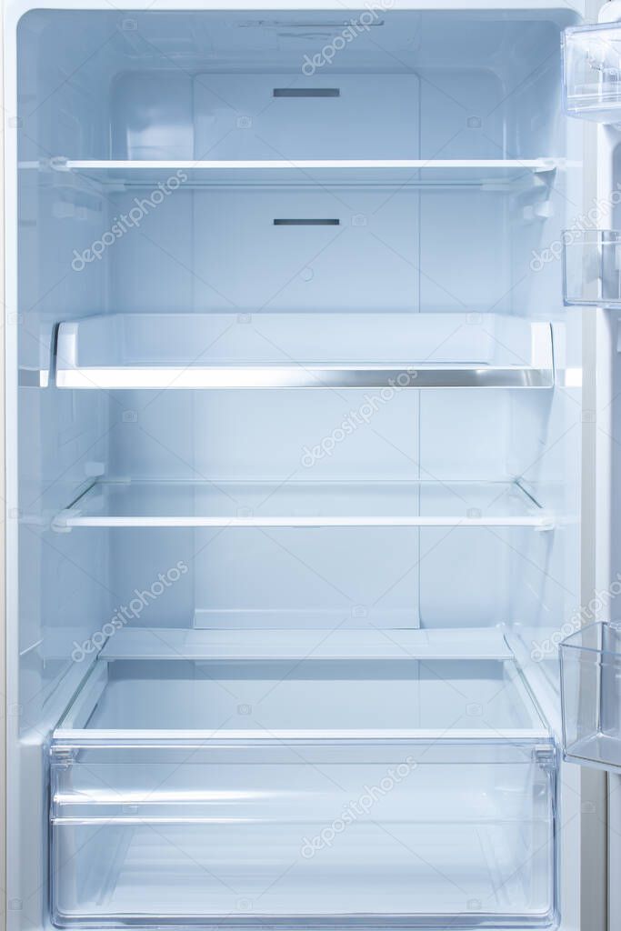 Empty open fridge with shelves, refrigerator. mockup background empty shelves for your products. open fridge shelf. Interior of an empty open white refrigerator. Vertical