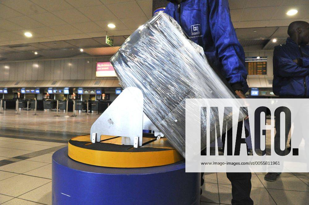 Baggage wrapped at airport to help prevent baggage theft - JOHANNESBURG, SOUTH AFRICA ? AUGUST 17: Baggage is wrapped at the OR Tambo International Airport on August 17, 2011 in Johannesburg, South Africa due to baggage theft. The situation which is getting out of control is prompting travellers to use alternatives to South African Airways. Gallo0000145030