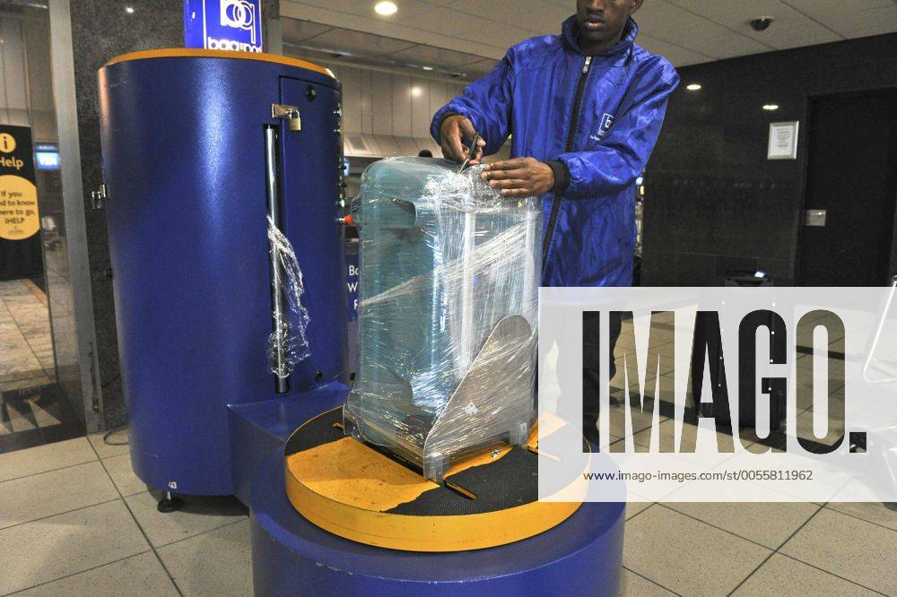 Baggage wrapped at airport to help prevent baggage theft - JOHANNESBURG, SOUTH AFRICA ? AUGUST 17: Baggage is wrapped at the OR Tambo International Airport on August 17, 2011 in Johannesburg, South Africa due to baggage theft. The situation which is getting out of control is prompting travellers to use alternatives to South African Airways. Gallo0000145032