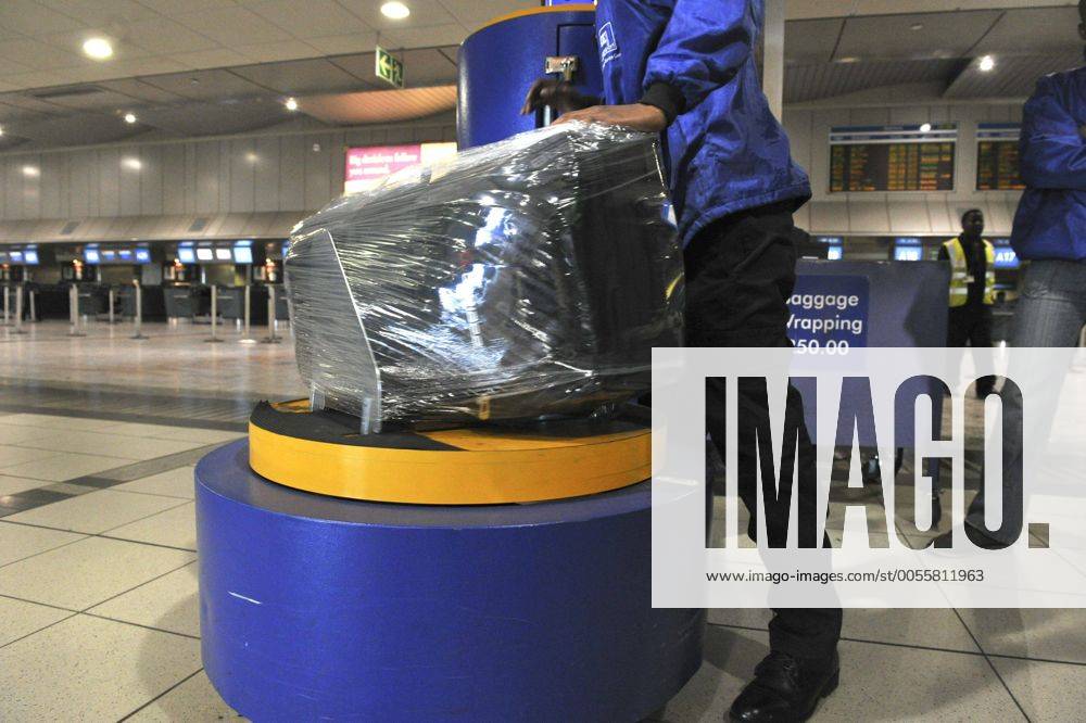Baggage wrapped at airport to help prevent baggage theft - JOHANNESBURG, SOUTH AFRICA ? AUGUST 17: Baggage is wrapped at the OR Tambo International Airport on August 17, 2011 in Johannesburg, South Africa due to baggage theft. The situation which is getting out of control is prompting travellers to use alternatives to South African Airways. Gallo0000145033