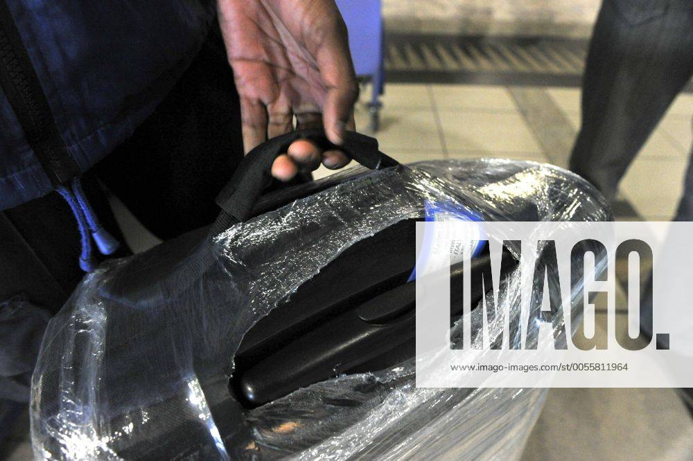 Baggage wrapped at airport to help prevent baggage theft - JOHANNESBURG, SOUTH AFRICA ? AUGUST 17: Baggage is wrapped at the OR Tambo International Airport on August 17, 2011 in Johannesburg, South Africa due to baggage theft. The situation which is getting out of control is prompting travellers to use alternatives to South African Airways. Gallo20114232