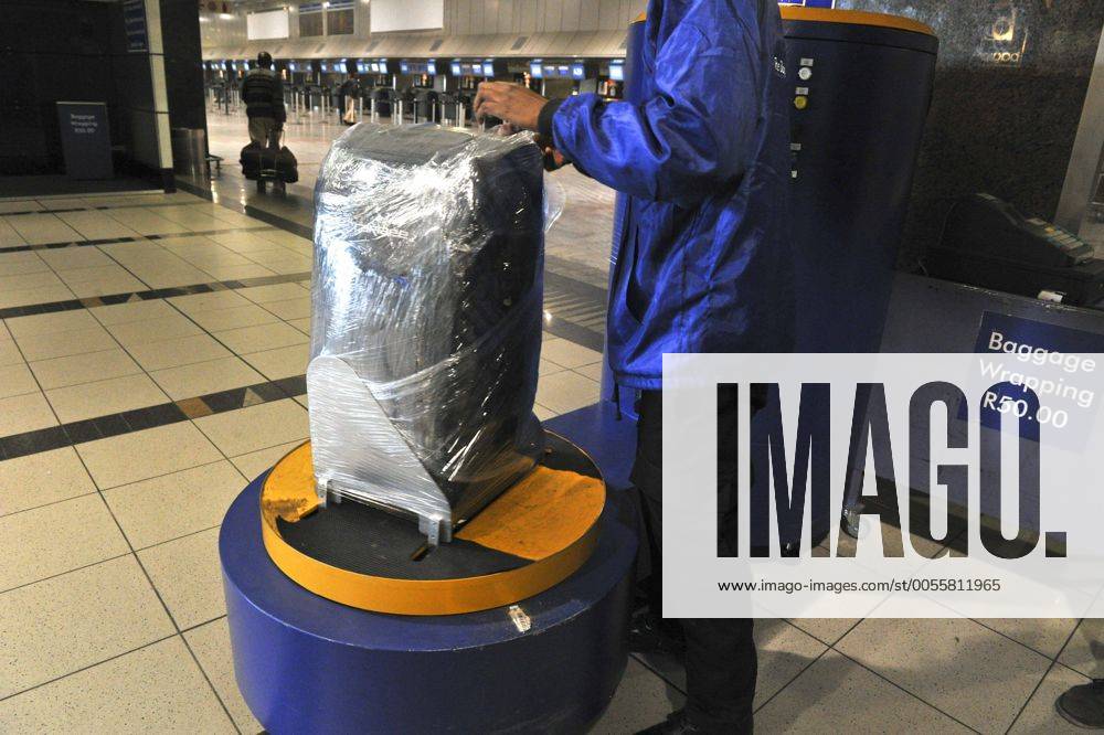 Baggage wrapped at airport to help prevent baggage theft - JOHANNESBURG, SOUTH AFRICA ? AUGUST 17: Baggage is wrapped at the OR Tambo International Airport on August 17, 2011 in Johannesburg, South Africa due to baggage theft. The situation which is getting out of control is prompting travellers to use alternatives to South African Airways. Gallo20114233