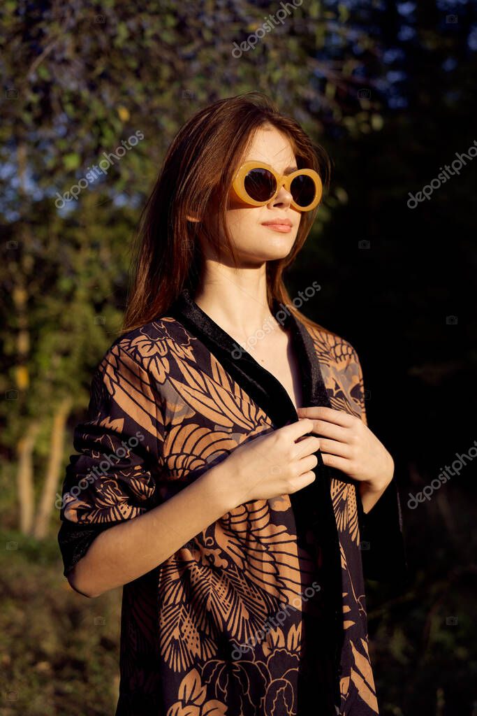 Woman wearing sunglasses outdoors posing fashion. High quality photo model released